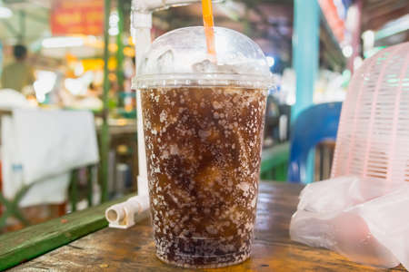 aerated soft drink with ice in plastic glassの写真素材