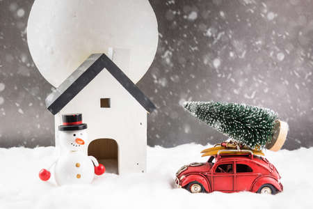 Decorative Christmas decorations, small house on a snowy backgroundの写真素材