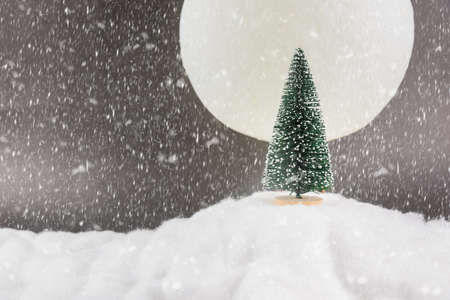 Decorative Christmas decorations on a snowy full moon backgroundの写真素材
