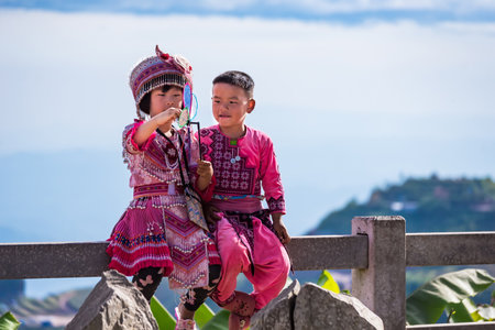 Phetchabun, Thailand - November, 29, 2020 : Hmong children in traditional clothes wait for pictures...