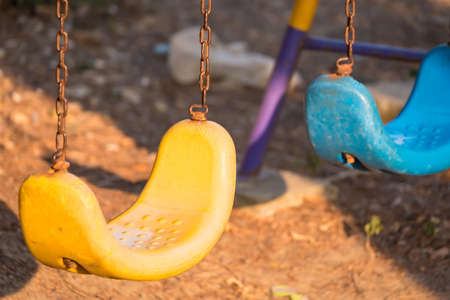 Empty swing with chains on the playgroundの写真素材