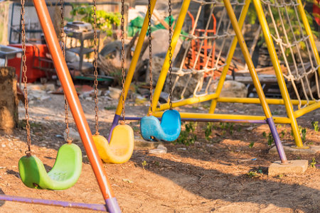 Empty swing with chains on the playground