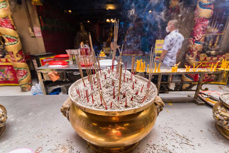 Ayutthaya, Thailand - February, 17, 2021 : brass pot incense burner with incense sticks at Wat Phanan Choeng in Ayutthaya, Thailandのeditorial素材