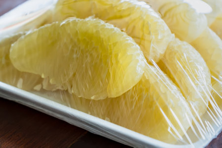 Pomelo is a natural citrus fruit on white plateの写真素材