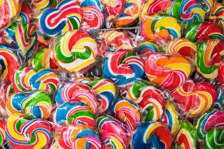 Many styles of colorful spiral lollipops for sale at grocery store In the market.Colorful candies...