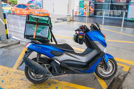 Bangkok, Thailand - May, 05, 2021 :  Parked motorcycle has a carrying box for food delivery work at...