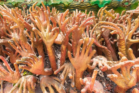 Hand sculpture of the ghost of hell. Representing human greed in Thai temples.のeditorial素材