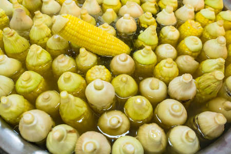 Boiled corn arranged in a basin for sale in the Thai market.の写真素材