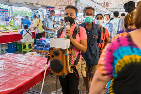 Bangkok, Thailand-June, 06, 2021:  Unidentified blind woman singing for donate money at the market at Bangkok, Thailandのeditorial素材