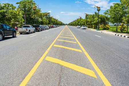 Bangkok, Thailand-June, 20, 2021 : Yellow line on the road texture background in Bangkok, Thailand.の写真素材