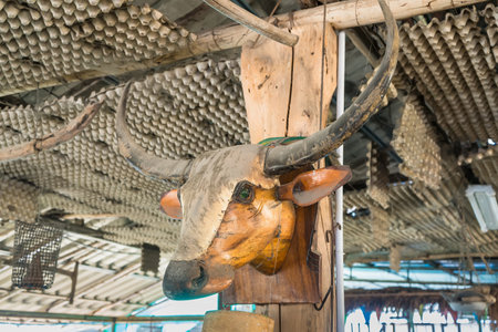 The head of a buffalo is made of wood to decorate the walls of the house.の写真素材