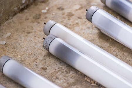 Straight Fluorescent Lamps on the cement floorの写真素材