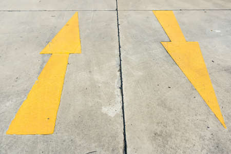Yellow street arrow sign shooting at day time