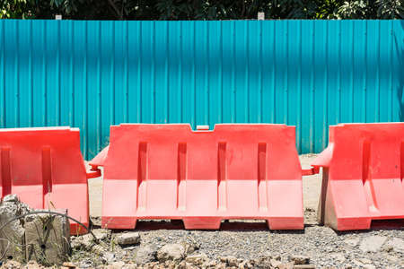 Orange plastic barrier lined up in rowsの写真素材