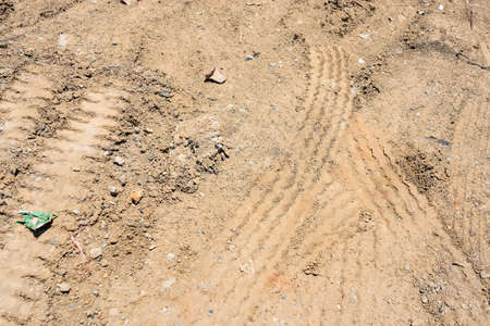 Tire tracks on a ground road, abstract backgroundの写真素材