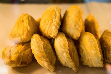 Curry puff pastry stuffed chicken and bean eat couple with tea cupの写真素材