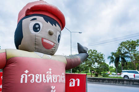 Bangkok, Thailand - October, 17, 2021 : Inflatable dolls are used to bring customers to a noodle shop in Bangkok, Thailand.のeditorial素材