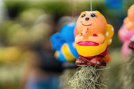 Cute cartoon ceramic hanging with air plant for Indoor outdoor decorative handmade.Beautiful Ornamental gardening clay doll.の写真素材