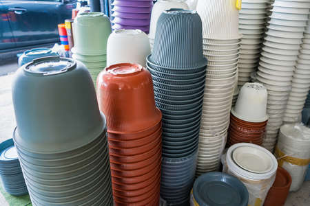various types of ceramic and plastic plant pots displayed in retail shopの写真素材