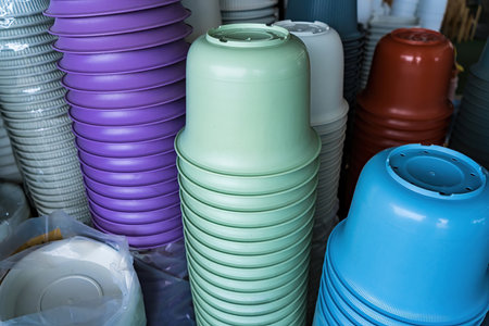 various types of ceramic and plastic plant pots displayed in retail shopの写真素材