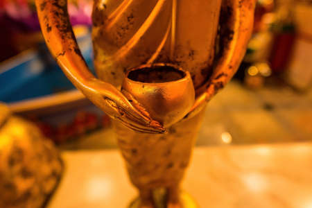 Buddha statue holding alms bowlの写真素材