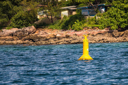 Yellow signalling buoy in the middle of the sea to help boatsの写真素材