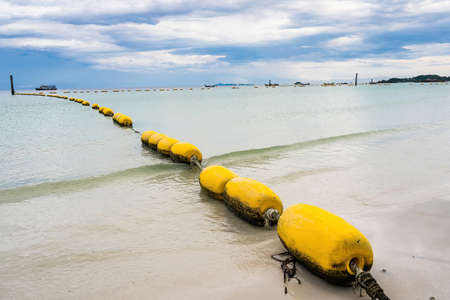 Close-up of the Old buoys at sandy beach in Thailandの写真素材