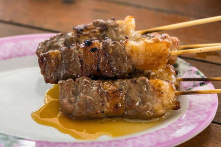 BBQ meat skewered on a charcoal grill.Delicious juicy grilled beefの写真素材