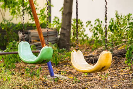 Empty swing with chains on the playground at thailand.の写真素材