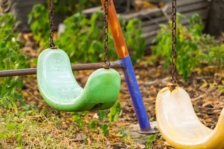 Empty swing with chains on the playground at thailand.の写真素材