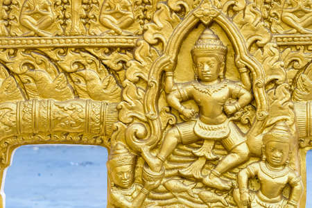 Bangkok, Thailand - April, 22, 2022 : Ancient golden figure on the wall at Buddhist temple at Bangkok, Thailand.のeditorial素材