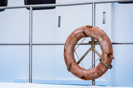 Orange safety Torus or lifebouy equipment installed beside a river for unexpected accidentの写真素材