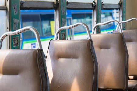 Bangkok, Thailand - May, 29, 2022 : Empty leather seat inside the vintage auto bus of bangkok metropolis, thailand transportationの写真素材