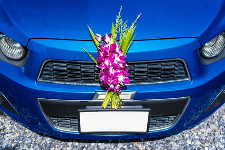 Bangkok, Thailand- August,13, 2022 : The bouquet of flowers is used to worship the sacred objects of the car in front of the car.の写真素材