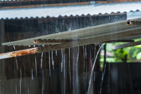 Rain on a Tin Roof. Rain Falling from the Roof. Rainy day nature background. Selective Focusの写真素材