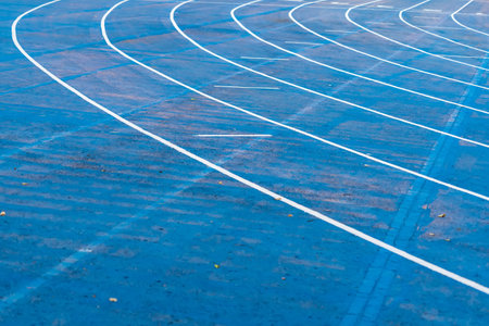 background of blue track for running competition at stadium, focus on center.の写真素材