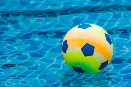 Inflatable colorful ball floating in a swimming pool.の写真素材