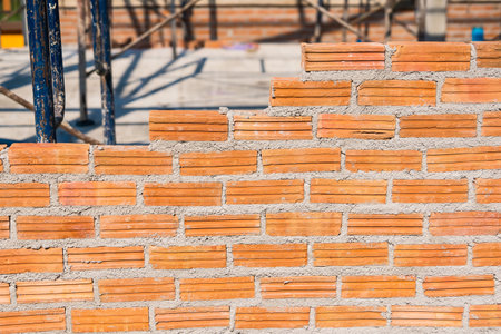 Building wall by mason on constrcution site
