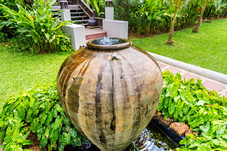Jar fountain decoration in the green garden.Thailandの写真素材