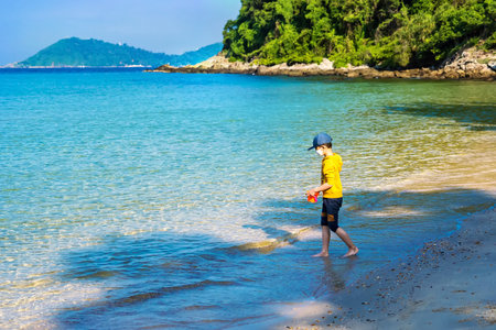 Rayong, Thailand - October, 15, 2022 : Small children playing in the sea in the tropical beach at the Koh Samet island, Rayong, Thailandのeditorial素材