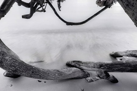 Black and white photo of long exposure of the sea waves on the beach.の写真素材