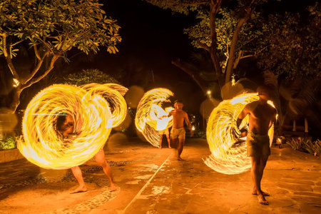 Bangkok, Thailand - October, 15, 2022 : Unidentified name Actors perform fire swinging at dusk in a...