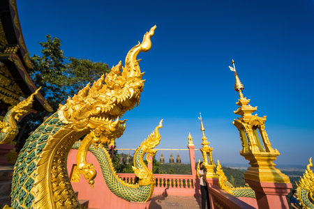Lampang, Thailand - December, 19, 2022 : Serpent railing with blue sky background at Wat Phra That...