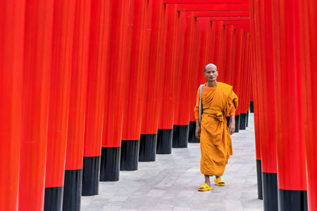 Chiang Mai, Thailand - December, 19, 2022 : Red Torii gates with monk in Hinoki Land new landmark...
