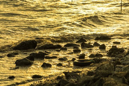 Mesmerizing Golden Hour:Enchanting Golden Waves Dancing Along the Coastline.の写真素材