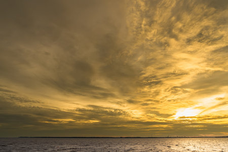 Mesmerizing Golden Hour:The evening sky over the sea is peaceful in Thailand.の写真素材