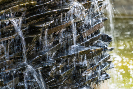 Nature's Beauty Unveiled: Enchanting Artificial Waterfall Adorns Coffee Shop's Gardenの写真素材