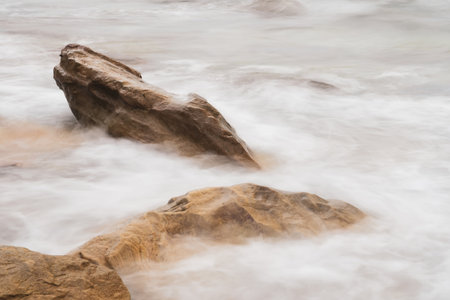 Majestic Evening Seascape: Dramatic Waves Collide with Island Rocks in Eastern Thailand at Sunsetの写真素材