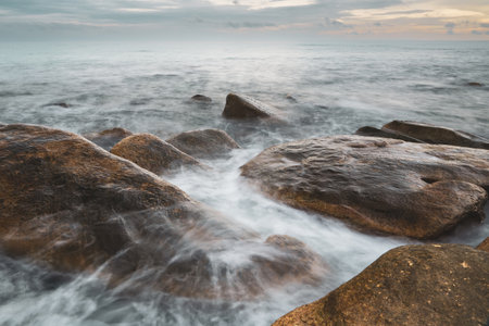 Majestic Evening Seascape: Dramatic Waves Collide with Island Rocks in Eastern Thailand at Sunsetの写真素材