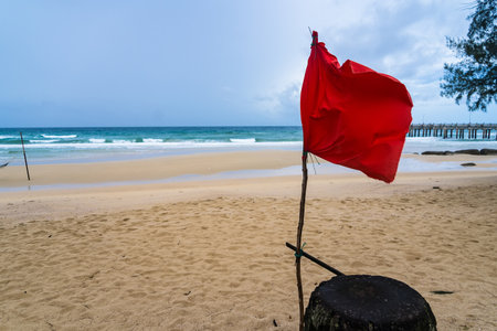 Maritime Alert: The Red Flag and Sea's Call for Cautionの写真素材